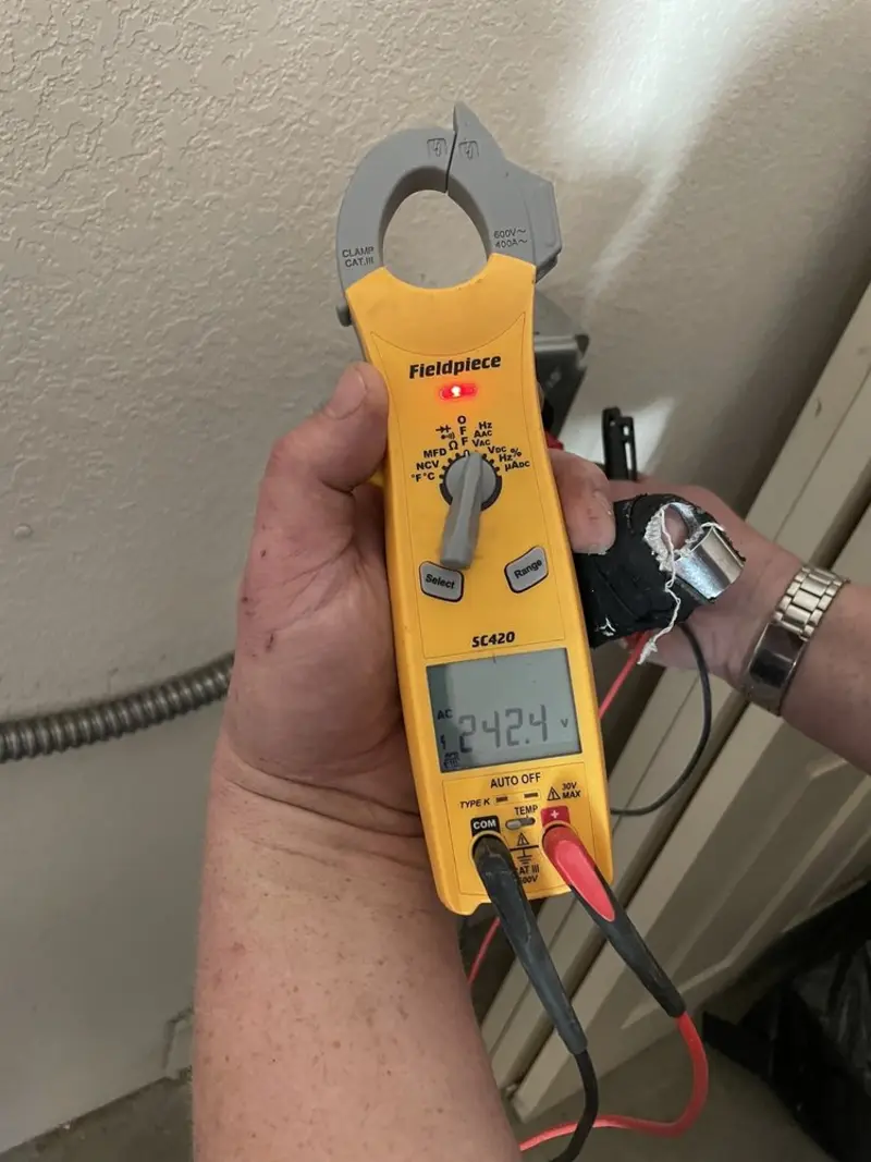 Voltage testing with clamp meter during Ceiling Fan Installation in Gaines